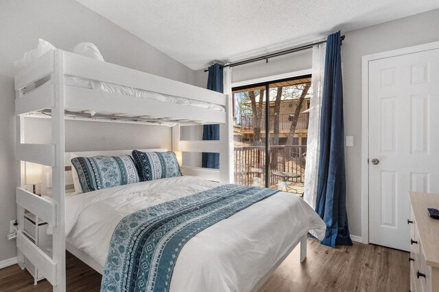 235 Ozark Mountain Resort Dr Unit 47, Kimberling City, MO 65686 - bedroom with baseboards, a textured ceiling, wood finished floors, and access to outside