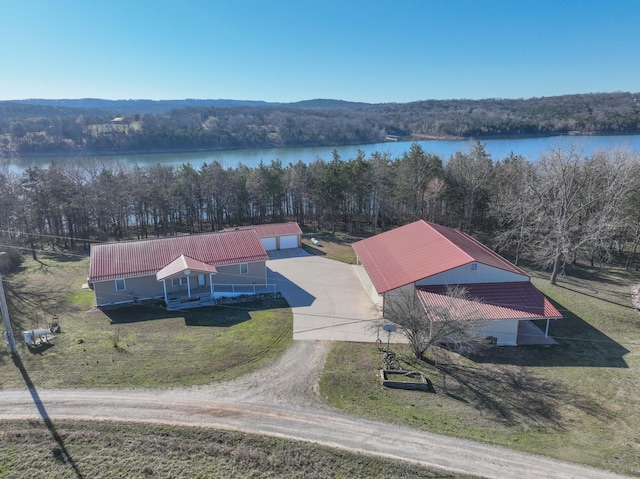 aerial view featuring a forest view and a water view