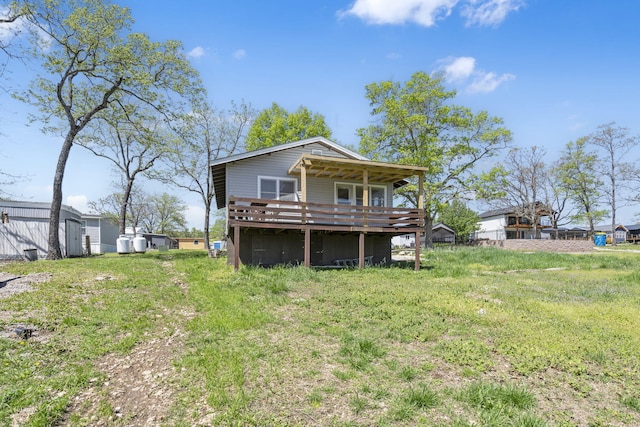 back of house with a deck