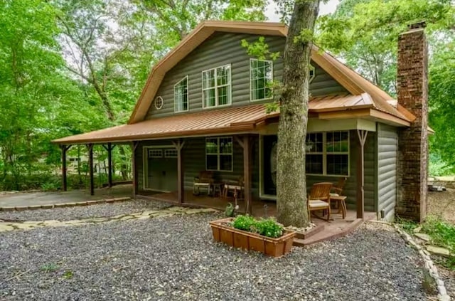 6881 E Rivers Edge Ln, Rogersville, MO 65742 - rear view of property with a chimney, metal roof, and a patio