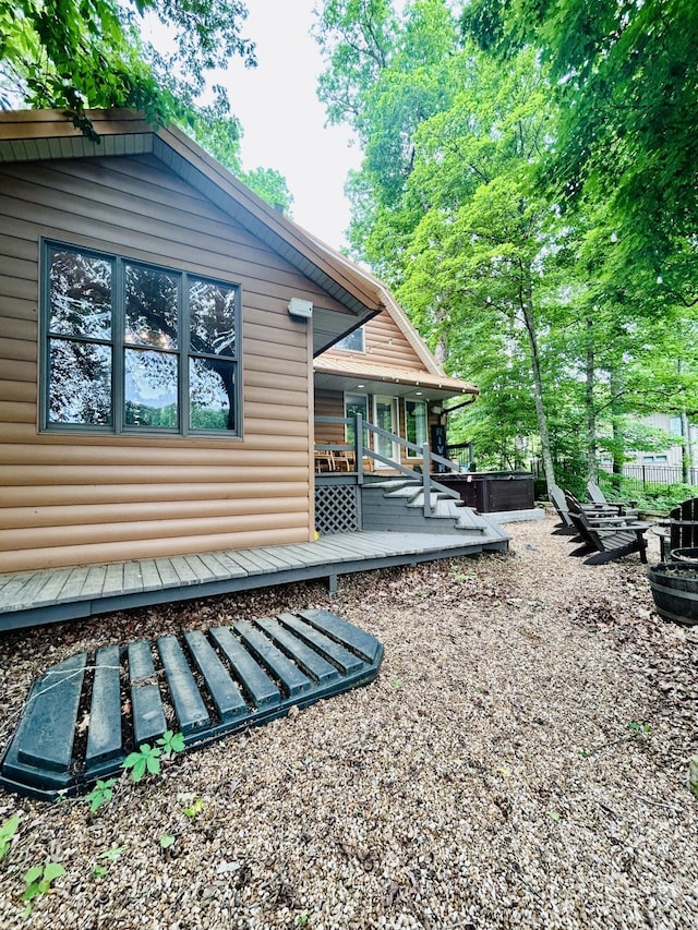 6881 E Rivers Edge Ln, Rogersville, MO 65742 - view of side of home with faux log siding, an outdoor fire pit, and a wooden deck