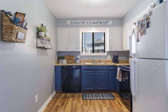 145 Starboard Dr Unit 8, Kimberling City, MO 65686 - kitchen with black appliances, a sink, blue cabinets, light wood-style flooring, and white cabinets