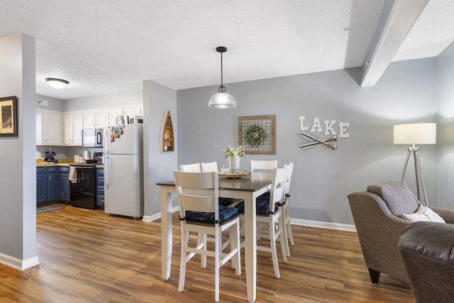 145 Starboard Dr Unit 8, Kimberling City, MO 65686 - dining area featuring baseboards and wood finished floors
