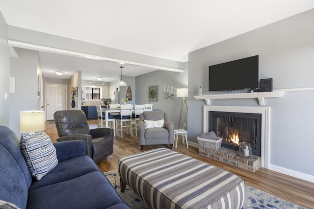 145 Starboard Dr Unit 8, Kimberling City, MO 65686 - living area featuring a fireplace, wood finished floors, and baseboards