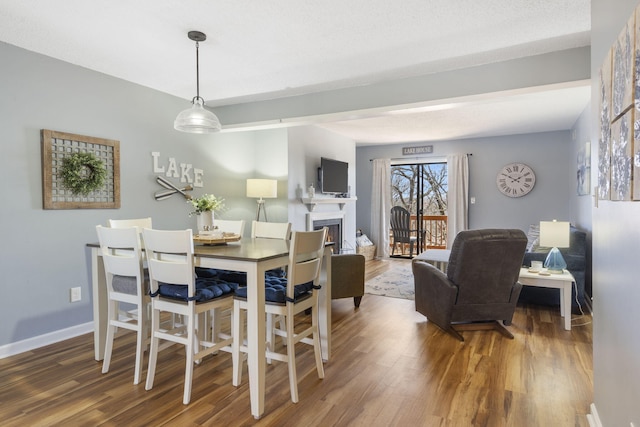 145 Starboard Dr Unit 8, Kimberling City, MO 65686 - dining room featuring wood finished floors, a fireplace, and baseboards