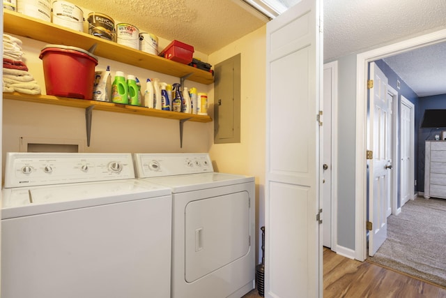 145 Starboard Dr Unit 8, Kimberling City, MO 65686 - washroom with a textured ceiling, electric panel, washing machine and clothes dryer, and light wood finished floors