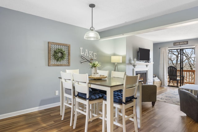 145 Starboard Dr Unit 8, Kimberling City, MO 65686 - dining space with wood finished floors, baseboards, and a warm lit fireplace