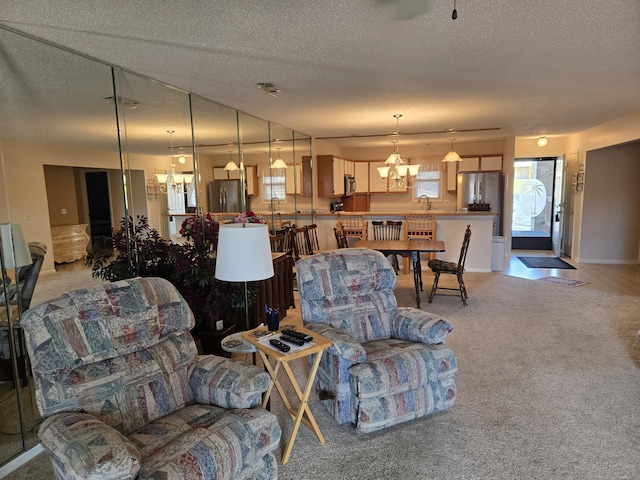 300 Port Dr Unit 5, Kimberling City, MO 65686 - living room with a textured ceiling, an inviting chandelier, and light colored carpet