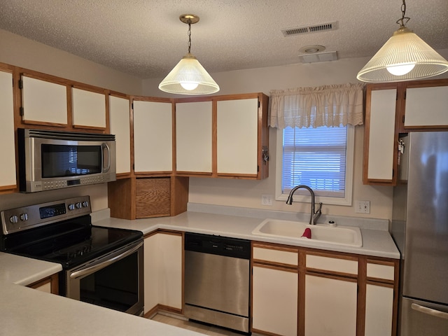300 Port Dr Unit 5, Kimberling City, MO 65686 - kitchen with light countertops, stainless steel appliances, hanging light fixtures, a sink, and visible vents