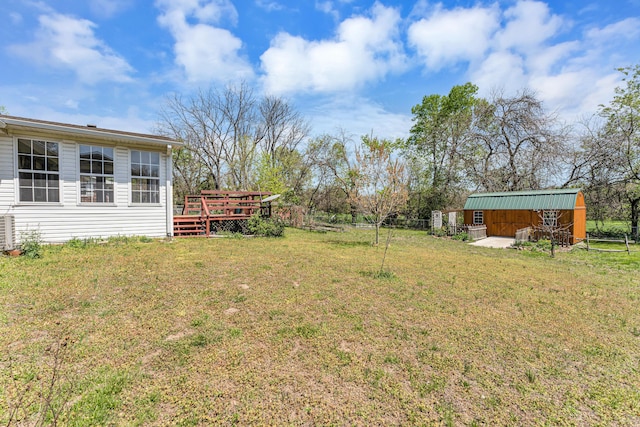view of yard with a wooden deck and fence
