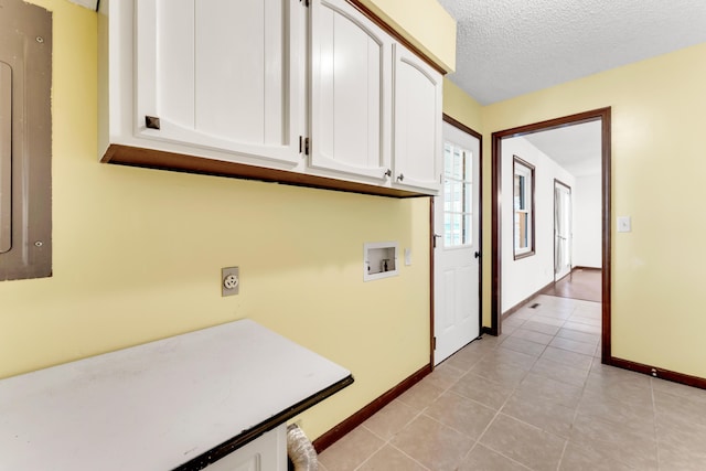 washroom featuring cabinet space, washer hookup, baseboards, and light tile patterned flooring