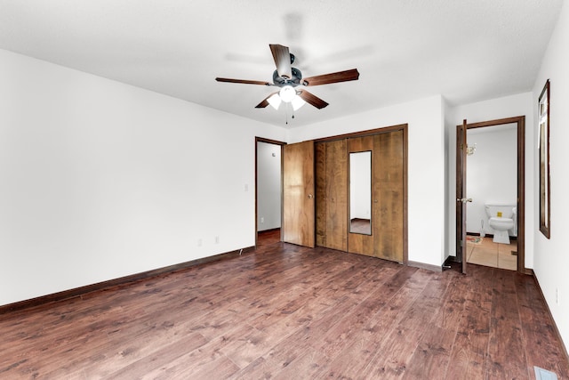 unfurnished bedroom featuring visible vents, a ceiling fan, a closet, baseboards, and dark wood-style flooring
