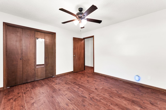 unfurnished bedroom with baseboards, a ceiling fan, wood finished floors, and a closet