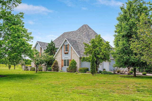 9041 N Country Manor Ln, Fair Grove, MO 65648 - english style home featuring stone siding, a front yard, stucco siding, and a high end roof