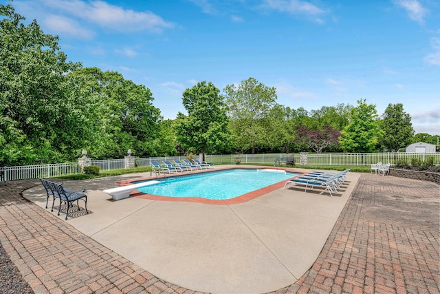 9041 N Country Manor Ln, Fair Grove, MO 65648 - view of swimming pool with a patio, a diving board, fence, and view of wooded area