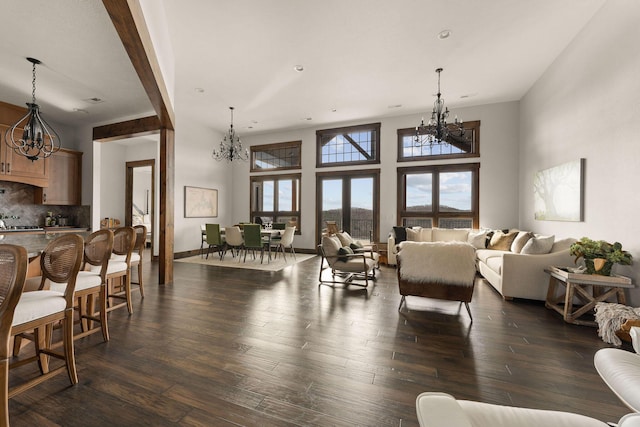 living area featuring an inviting chandelier and dark wood-style floors