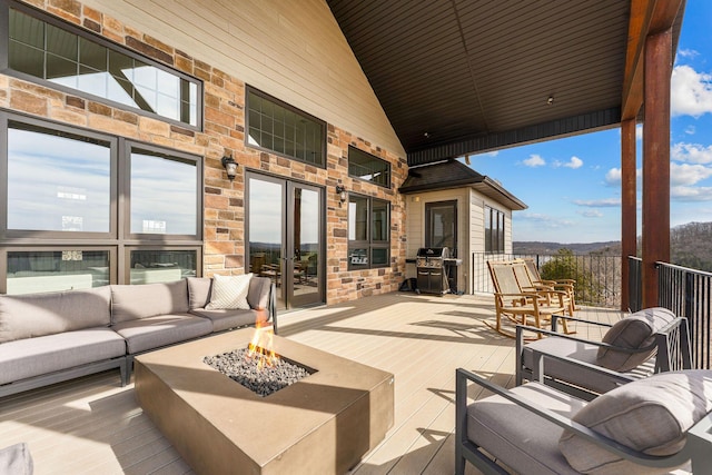 view of patio / terrace featuring french doors, a grill, and an outdoor living space with a fire pit
