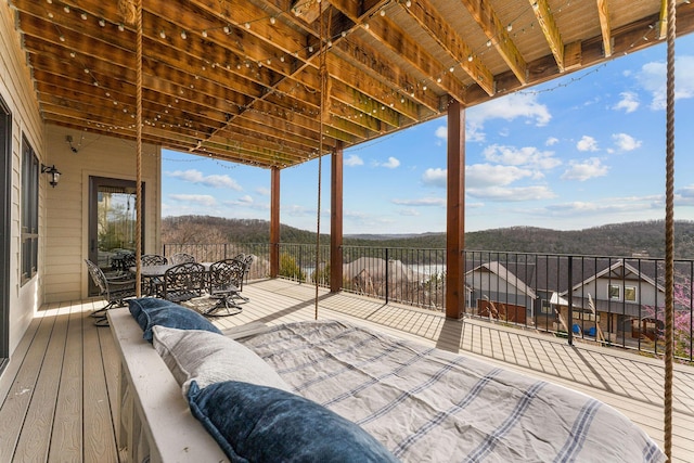 wooden terrace with outdoor dining area