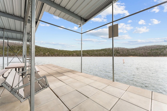 dock area with a water view and a forest view