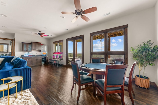 dining space featuring dark wood-type flooring, ceiling fan, visible vents, and recessed lighting