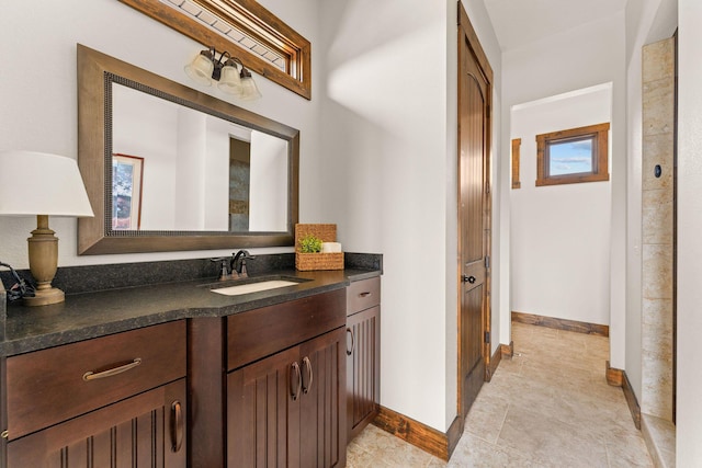 bathroom featuring baseboards and vanity