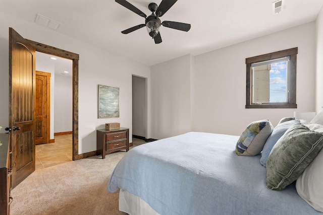 bedroom featuring ceiling fan, light colored carpet, baseboards, and visible vents