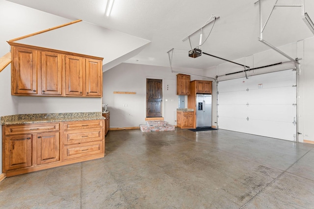 garage featuring a garage door opener, stainless steel fridge with ice dispenser, and baseboards