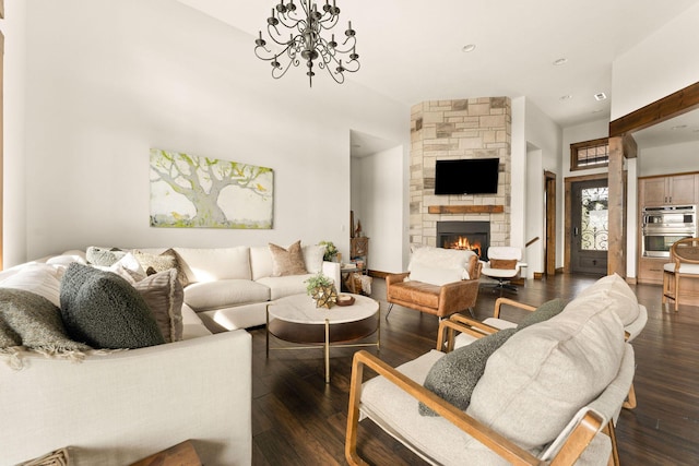 living area with dark wood-type flooring, recessed lighting, and a fireplace