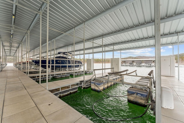 dock area with a water view and boat lift