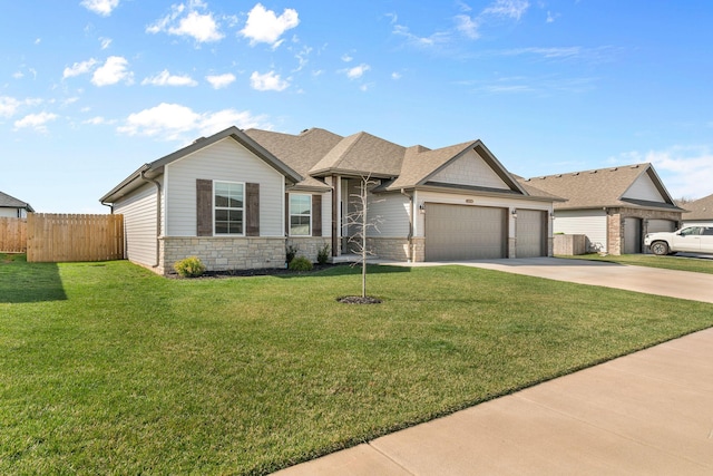 view of front facade with concrete driveway, fence, an attached garage, stone siding, and a front lawn