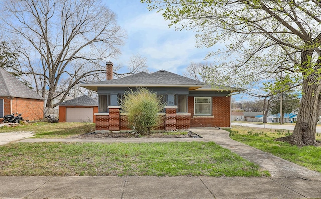 218 Lillian Pl, Bolivar, MO 65613 - bungalow featuring an outdoor structure, a front lawn, brick siding, a garage, and a chimney