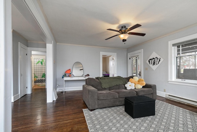 218 Lillian Pl, Bolivar, MO 65613 - living room with crown molding, baseboards, baseboard heating, a ceiling fan, and dark wood finished floors