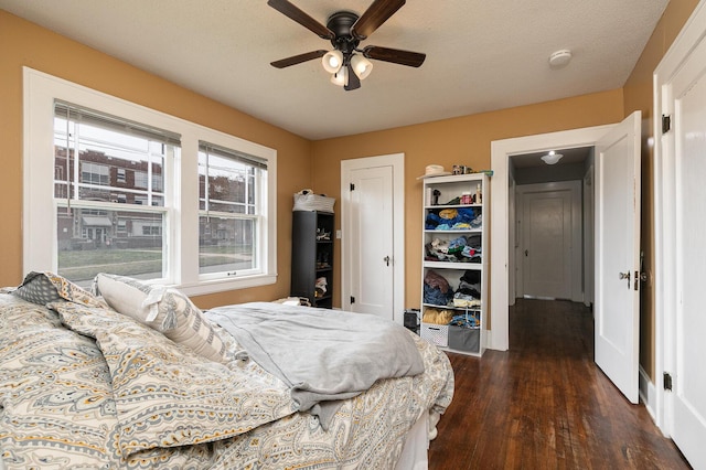218 Lillian Pl, Bolivar, MO 65613 - bedroom featuring a ceiling fan, dark wood-type flooring, a closet, and a textured ceiling