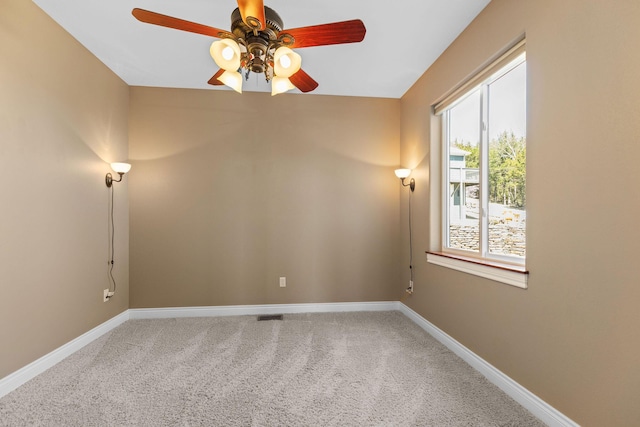 carpeted empty room with baseboards and ceiling fan