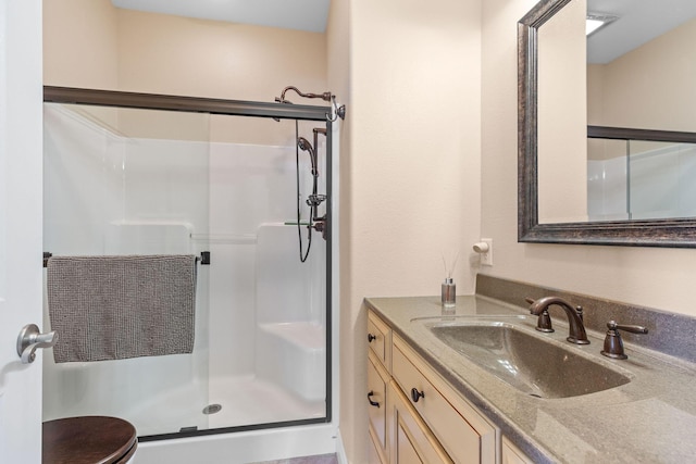 full bath featuring vanity and a shower stall