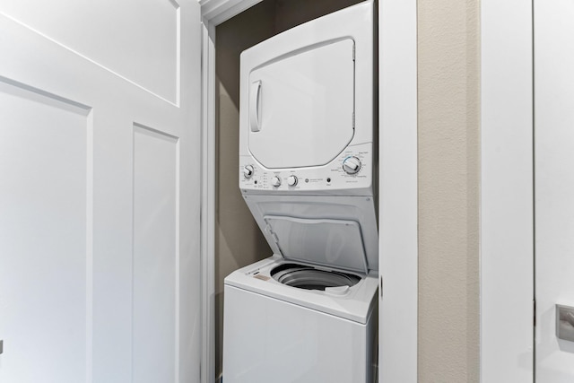 201-217 Watersound Way, Hollister, MO 65672 - laundry area with stacked washer / dryer and laundry area