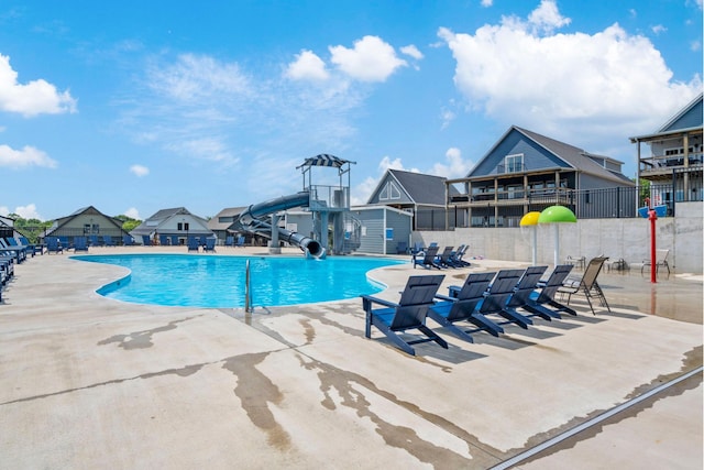 201-217 Watersound Way, Hollister, MO 65672 - pool with fence, a water slide, and a patio area