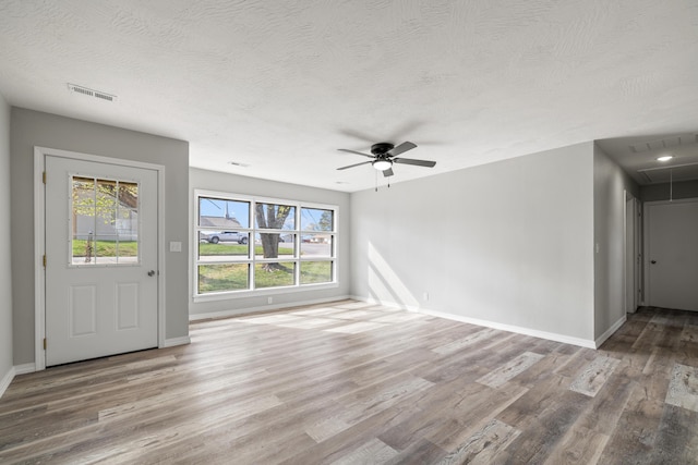 200 N Madison Ave, Mansfield, MO 65704 - unfurnished living room featuring a healthy amount of sunlight, attic access, and wood finished floors