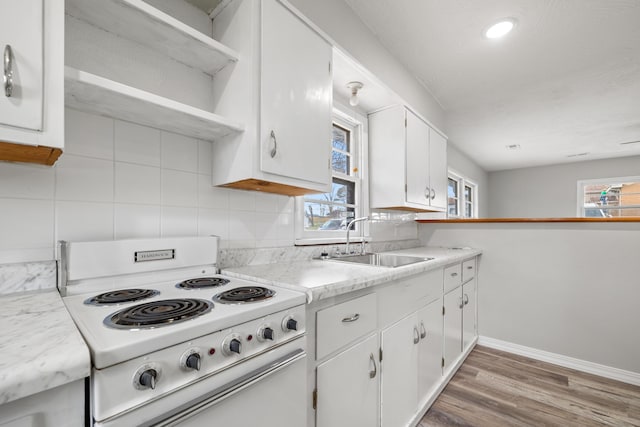 200 N Madison Ave, Mansfield, MO 65704 - kitchen featuring baseboards, backsplash, a sink, white electric stove, and white cabinets
