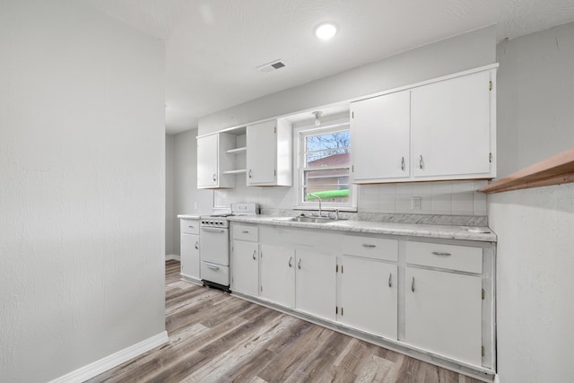 200 N Madison Ave, Mansfield, MO 65704 - kitchen featuring a sink, white cabinetry, white gas range, and open shelves