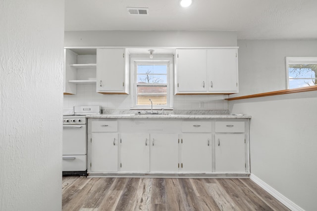 200 N Madison Ave, Mansfield, MO 65704 - kitchen featuring light countertops, white electric range, white cabinetry, a sink, and open shelves