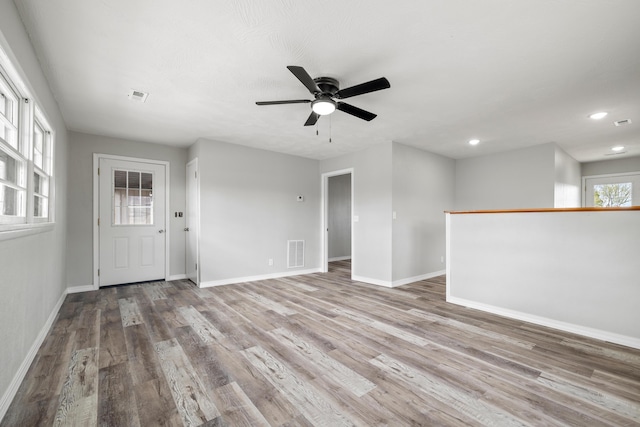 200 N Madison Ave, Mansfield, MO 65704 - unfurnished living room with a ceiling fan, wood finished floors, and visible vents