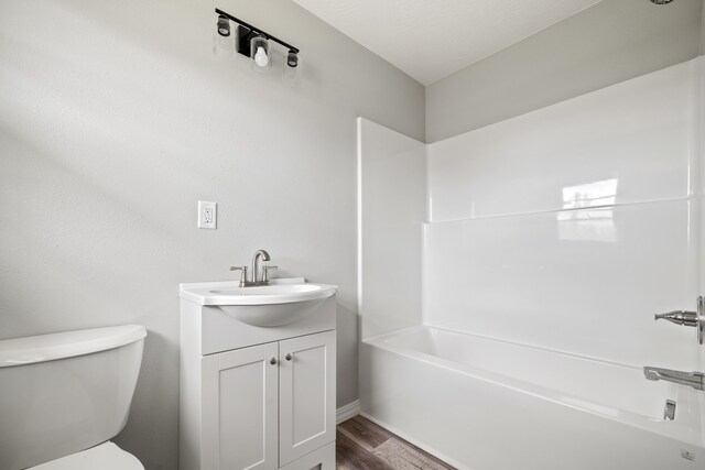 200 N Madison Ave, Mansfield, MO 65704 - full bath with wood finished floors, toilet, vanity, and shower / bathtub combination