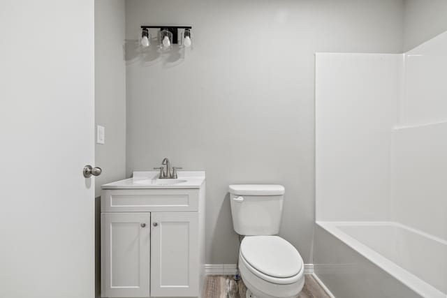 200 N Madison Ave, Mansfield, MO 65704 - bathroom featuring toilet, vanity, baseboards, and wood finished floors