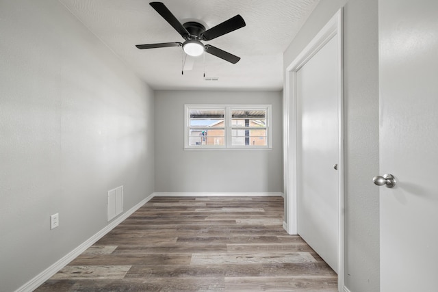 200 N Madison Ave, Mansfield, MO 65704 - empty room with visible vents, baseboards, ceiling fan, and wood finished floors