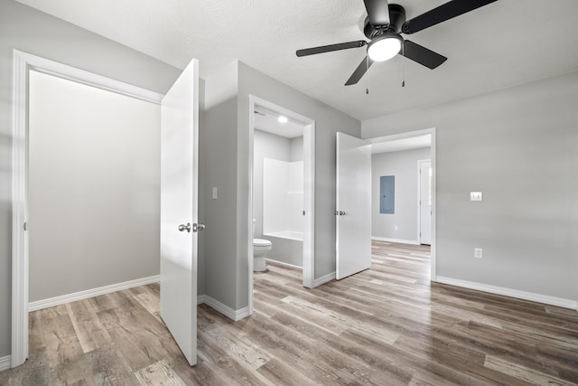 200 N Madison Ave, Mansfield, MO 65704 - interior space featuring electric panel, a ceiling fan, wood finished floors, ensuite bath, and baseboards
