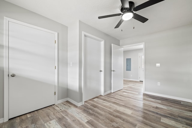 200 N Madison Ave, Mansfield, MO 65704 - unfurnished bedroom featuring electric panel, baseboards, wood finished floors, and a ceiling fan