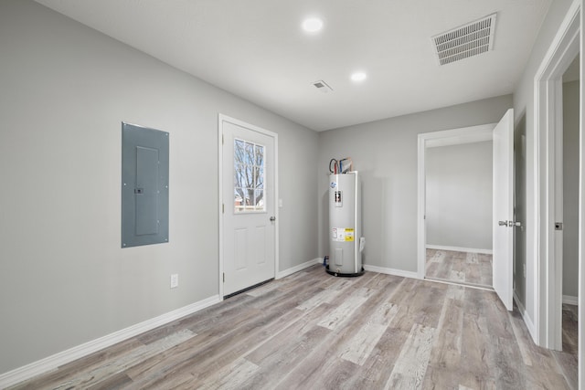 200 N Madison Ave, Mansfield, MO 65704 - entrance foyer with water heater, baseboards, light wood-style floors, visible vents, and electric panel