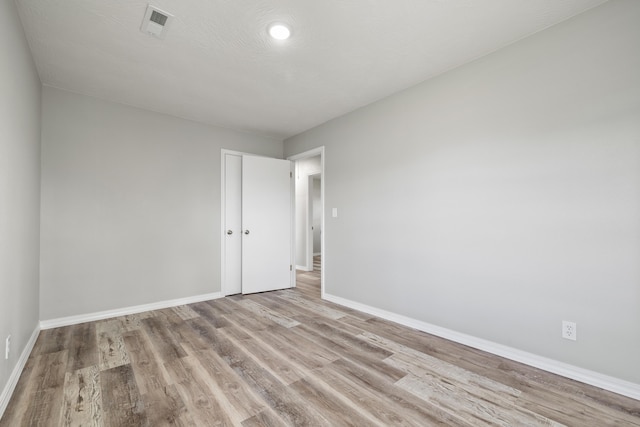 200 N Madison Ave, Mansfield, MO 65704 - unfurnished room featuring baseboards, visible vents, and light wood finished floors