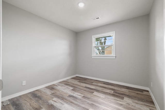 200 N Madison Ave, Mansfield, MO 65704 - spare room featuring baseboards, visible vents, and wood finished floors